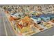 Aerial view of a two-story home with an open front yard and backyard with a red fence surrounding the property at 14425 E 50Th Ave, Denver, CO 80239