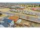 A home near a school complex featuring a running track, playing fields, school building, and parking lot at 14425 E 50Th Ave, Denver, CO 80239