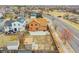 Aerial view of the backyard with a red fence, small shed, patio area, and a garden, in a residential neighborhood at 14425 E 50Th Ave, Denver, CO 80239