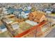 Aerial view of the backyard with a red fence, small shed, and a patio area, perfect for outdoor relaxation at 14425 E 50Th Ave, Denver, CO 80239