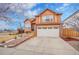 Charming two-story home featuring a spacious driveway and a well-maintained front yard with beautiful landscaping at 14425 E 50Th Ave, Denver, CO 80239