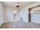 Cozy bedroom featuring an open closet with shelving, neutral walls, and carpet at 9955 Fillmore St, Thornton, CO 80229