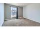 Bright bedroom featuring a window with neighborhood views and neutral carpet at 9955 Fillmore St, Thornton, CO 80229