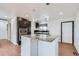 Modern eat-in kitchen with a granite island, black cabinets, stainless steel appliances, and wood floors at 9955 Fillmore St, Thornton, CO 80229