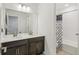 Stylish bathroom with double sink vanity and a shower with modern tiling at 27593 E 1St Pl, Aurora, CO 80018