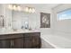 Bright bathroom features double sinks, a large mirror, and a soaking tub at 27593 E 1St Pl, Aurora, CO 80018