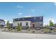 Attractive townhome featuring a red front door and a stone and siding exterior at 27593 E 1St Pl, Aurora, CO 80018