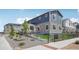 Modern townhome with manicured landscaping, fenced yard and stone and siding at 27593 E 1St Pl, Aurora, CO 80018