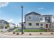 Two-story townhouse with stone facade, a small front yard, and a black metal fence at 27593 E 1St Pl, Aurora, CO 80018