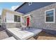 Charming front porch with stone accents and a welcoming red door, perfect for relaxing outdoors at 27593 E 1St Pl, Aurora, CO 80018