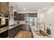 Contemporary kitchen featuring granite countertops, stainless steel appliances, and dark wood cabinetry at 27593 E 1St Pl, Aurora, CO 80018
