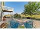 Spacious backyard patio with lounge seating and landscaped greenery at 881 Kirby Ct, Watkins, CO 80137