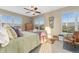 Bright bedroom with multiple windows offering natural light, a ceiling fan and carpet flooring at 881 Kirby Ct, Watkins, CO 80137