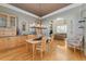 Bright dining room with wood cabinetry, a chandelier, and views into the living area at 881 Kirby Ct, Watkins, CO 80137