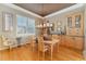 Sunlit dining room featuring wood cabinetry, a chandelier, and a large window at 881 Kirby Ct, Watkins, CO 80137
