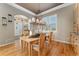 Elegant dining room with a chandelier, wood floors, and natural light at 881 Kirby Ct, Watkins, CO 80137