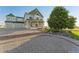 Stunning two-story home with manicured landscaping, three-car garage, and a charming front porch at 881 Kirby Ct, Watkins, CO 80137