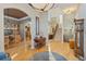 Elegant foyer with hardwood floors, staircase, and a view of the dining and living areas at 881 Kirby Ct, Watkins, CO 80137