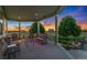Relaxing covered porch featuring comfortable seating and a beautiful outdoor view at sunset at 881 Kirby Ct, Watkins, CO 80137