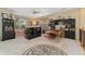 A home office with multiple windows, carpet flooring, ceiling fan and storage at 881 Kirby Ct, Watkins, CO 80137