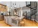 Kitchen with island with granite countertops, stainless steel appliances and a black spiral staircase at 881 Kirby Ct, Watkins, CO 80137