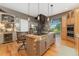 Kitchen island with granite countertops, seating, a spiral staircase and stainless steel appliances at 881 Kirby Ct, Watkins, CO 80137