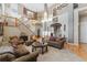 Inviting living room with a staircase, large windows, and comfortable seating arrangement at 881 Kirby Ct, Watkins, CO 80137