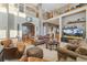 Comfortable living room featuring an open layout, large TV, and natural light at 881 Kirby Ct, Watkins, CO 80137