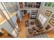 Open-concept living room with high ceilings, hardwood floors, comfortable seating, and a staircase at 881 Kirby Ct, Watkins, CO 80137