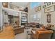 Bright living room featuring a high ceiling, second story, and large window at 881 Kirby Ct, Watkins, CO 80137