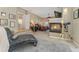 Bright main bedroom with a fireplace and a luxurious chaise lounge at 881 Kirby Ct, Watkins, CO 80137