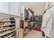 Organized walk-in closet with shelving and hanging storage solutions at 881 Kirby Ct, Watkins, CO 80137