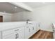 Basement bar with white cabinets and quartz countertops at 8791 Yellowcress St, Littleton, CO 80125