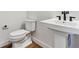 Simple powder room with pedestal sink and toilet at 8791 Yellowcress St, Littleton, CO 80125