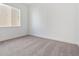 Simple carpeted bedroom with a large window at 8791 Yellowcress St, Littleton, CO 80125