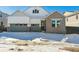 Two-story house with gray siding and a snow-covered front yard at 8791 Yellowcress St, Littleton, CO 80125
