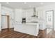 Modern kitchen with white cabinets and a large island at 8791 Yellowcress St, Littleton, CO 80125