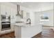 Modern kitchen with white cabinets, quartz countertops, and stainless steel appliances at 8791 Yellowcress St, Littleton, CO 80125
