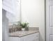 Bright bathroom features a modern vanity, granite countertop, and updated faucet at 4519 Silver Mountain Loop, Broomfield, CO 80023