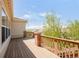 Spacious deck featuring wood flooring, brick accents, and views of the neighborhood at 4519 Silver Mountain Loop, Broomfield, CO 80023