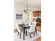 Cozy dining area features a stylish chandelier, a modern art piece, and views to the kitchen at 4519 Silver Mountain Loop, Broomfield, CO 80023