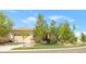 Charming front exterior with a manicured lawn, mature trees, and a beige two-car garage at 4519 Silver Mountain Loop, Broomfield, CO 80023