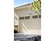 A beige garage door with inset windows is adorned with the house numbers 4519 at 4519 Silver Mountain Loop, Broomfield, CO 80023
