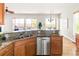 Well-lit kitchen with granite countertops and stainless steel dishwasher, perfect for modern living at 4519 Silver Mountain Loop, Broomfield, CO 80023
