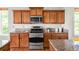Well-equipped kitchen featuring stainless steel appliances, wooden cabinets, and granite countertops at 4519 Silver Mountain Loop, Broomfield, CO 80023
