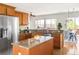 Bright, spacious kitchen with island, stainless steel refrigerator, and granite counters at 4519 Silver Mountain Loop, Broomfield, CO 80023