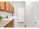 Well-equipped laundry room features granite countertops, a utility sink, and ample cabinet space at 4519 Silver Mountain Loop, Broomfield, CO 80023
