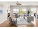 Comfortable living room area with a fireplace, large windows, and stylish furnishings at 4519 Silver Mountain Loop, Broomfield, CO 80023