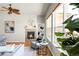 Cozy living room with fireplace, plush seating, and lots of natural light from large windows at 4519 Silver Mountain Loop, Broomfield, CO 80023