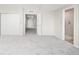 A spacious main bedroom features neutral paint and carpet leading to the ensuite bath at 4519 Silver Mountain Loop, Broomfield, CO 80023